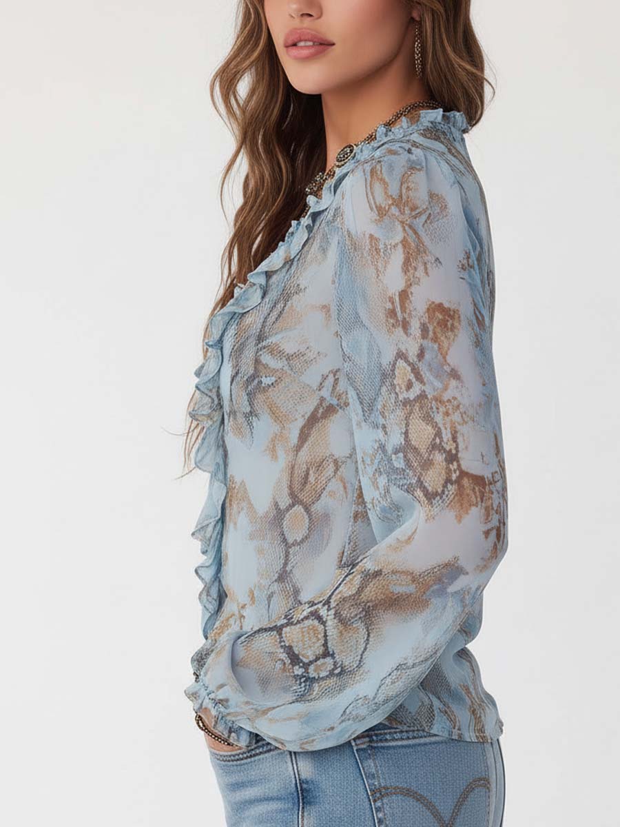 Celeste - Blusa de gasa con volantes y cremallera frontal en un sereno estampado azul.