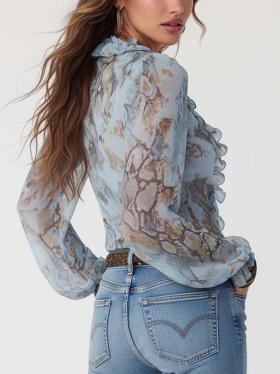 Celeste - Blusa de gasa con volantes y cremallera frontal en un sereno estampado azul.